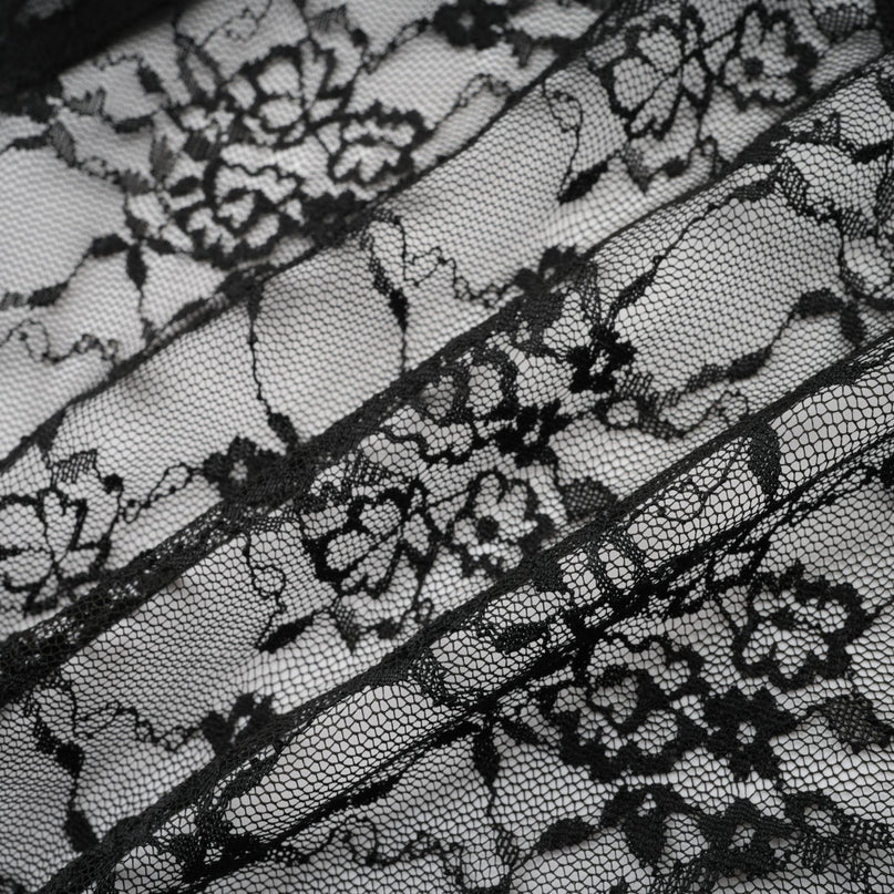 A black floral lace sleeveless vest and dress set featuring delicate lace patterns worn together as a matching outfit