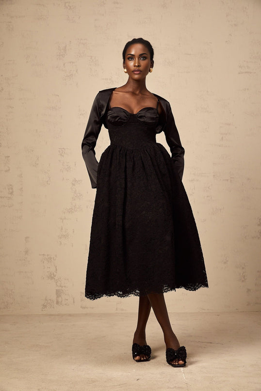 A black floral lace top and matching dress set featuring a sleeveless top and a fitted dress with delicate lace patterns