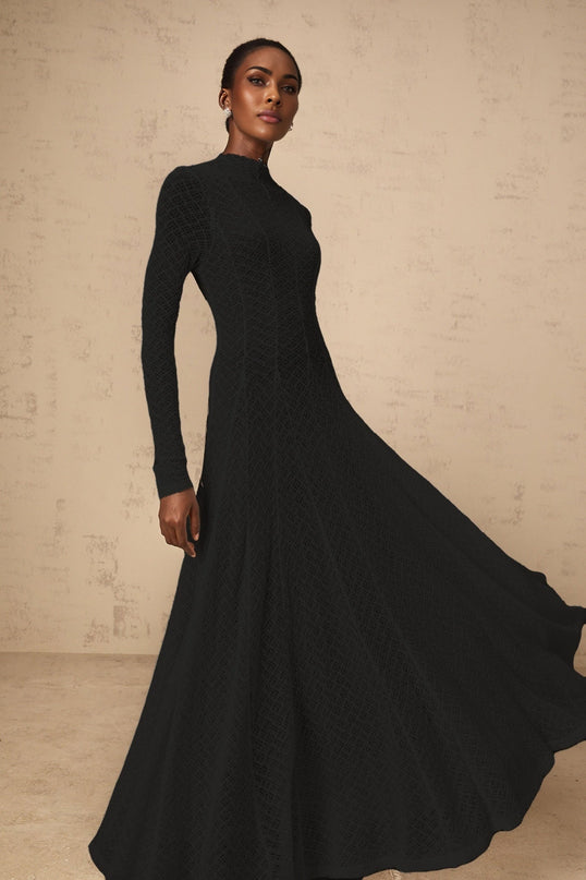 A black fulllength maxi dress with a wavy lace pattern covering the entire garment creating an elegant and intricate design