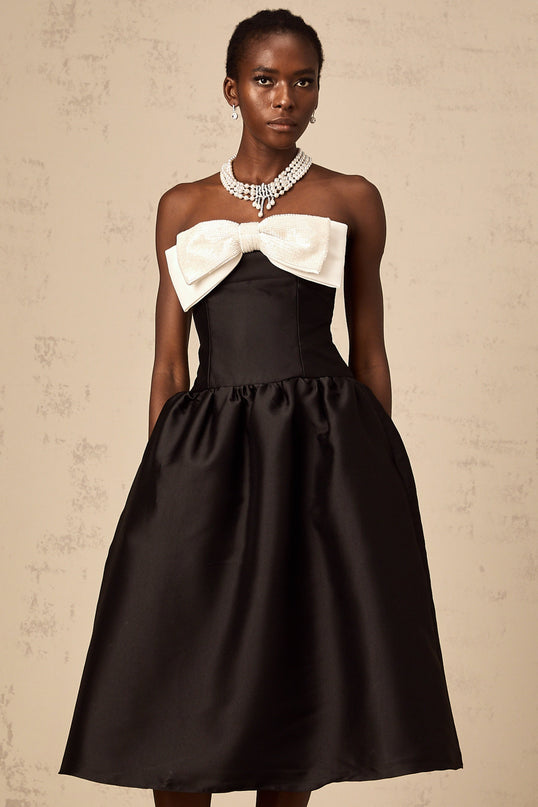 A black georgette midi dress with an offshoulder neckline and a bow detail