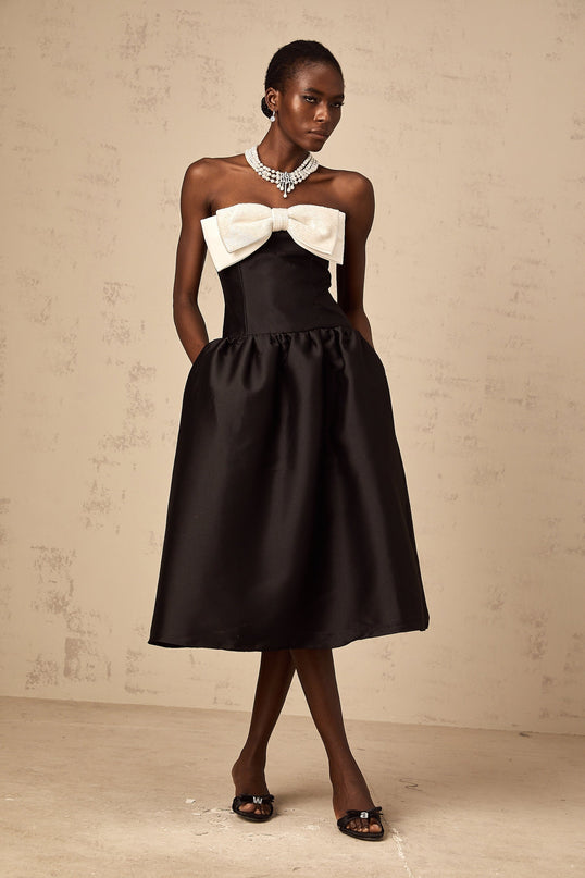 A black georgette midi dress with an offshoulder neckline and a decorative bowknot detail