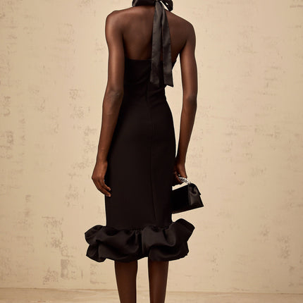 A black halterneck midi dress with a bubble hem featuring a fitted bodice and flared skirt silhouette