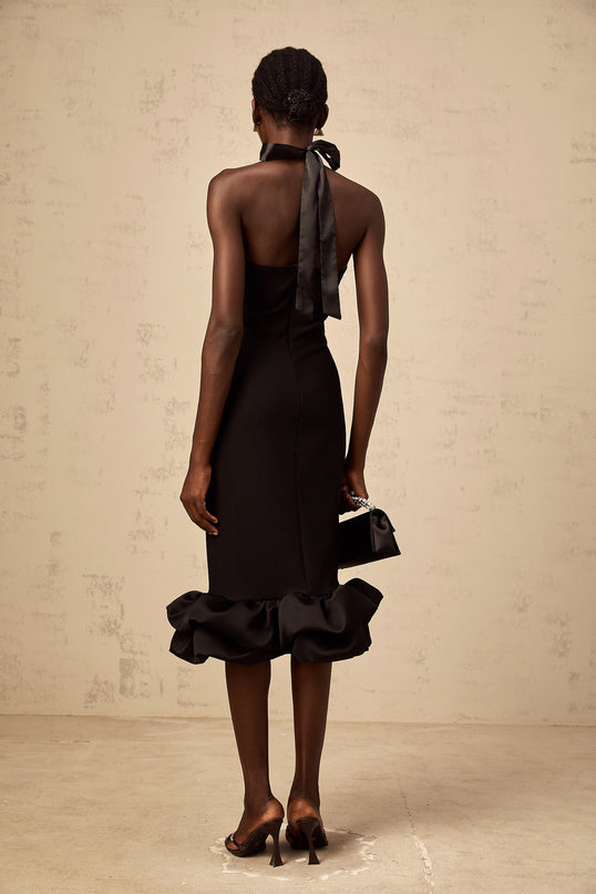 A black halterneck midi dress with a bubble hem featuring a fitted bodice and flared skirt silhouette