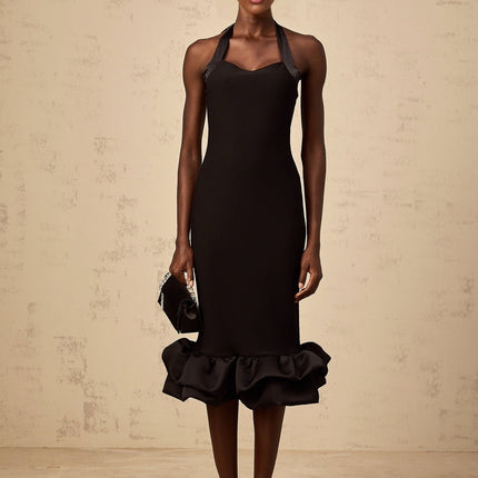 A black halterneck midi dress with a bubble hem featuring a fitted bodice and flared skirt silhouette
