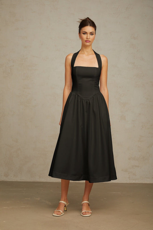 A black halterneck midi dress with pleated details and a fitted waist