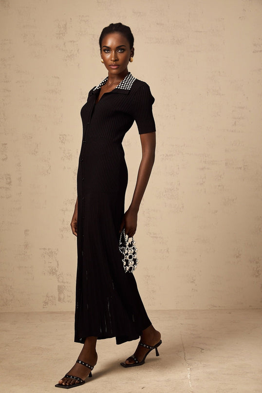 A black knit midi dress with studded embellishments called Laetitia featuring a fitted silhouette and long sleeves