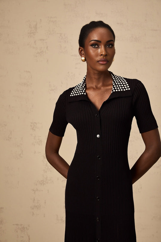 A black knit midi dress with studded embellishments named Laetitia featuring a fitted silhouette and long sleeves