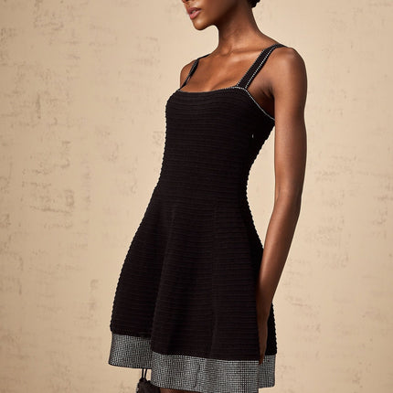 A black knit mini dress with a flared skirt and studded details named Eliane