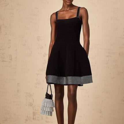 A black knit mini dress with flared skirt and studded details named Eliane