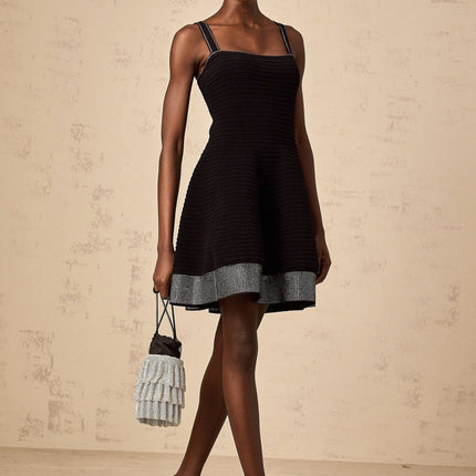 A black knit mini dress with flared skirt and studded details named Eliane