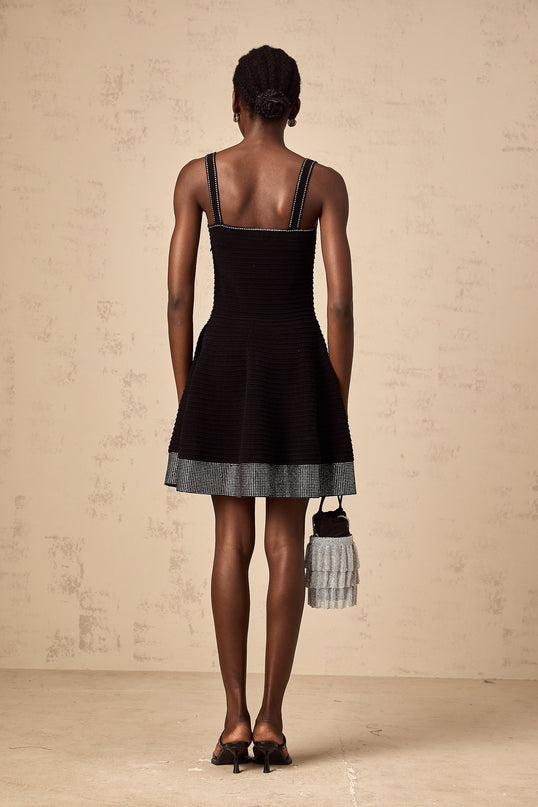 A black knit mini dress with flared skirt and studded embellishments named Eliane