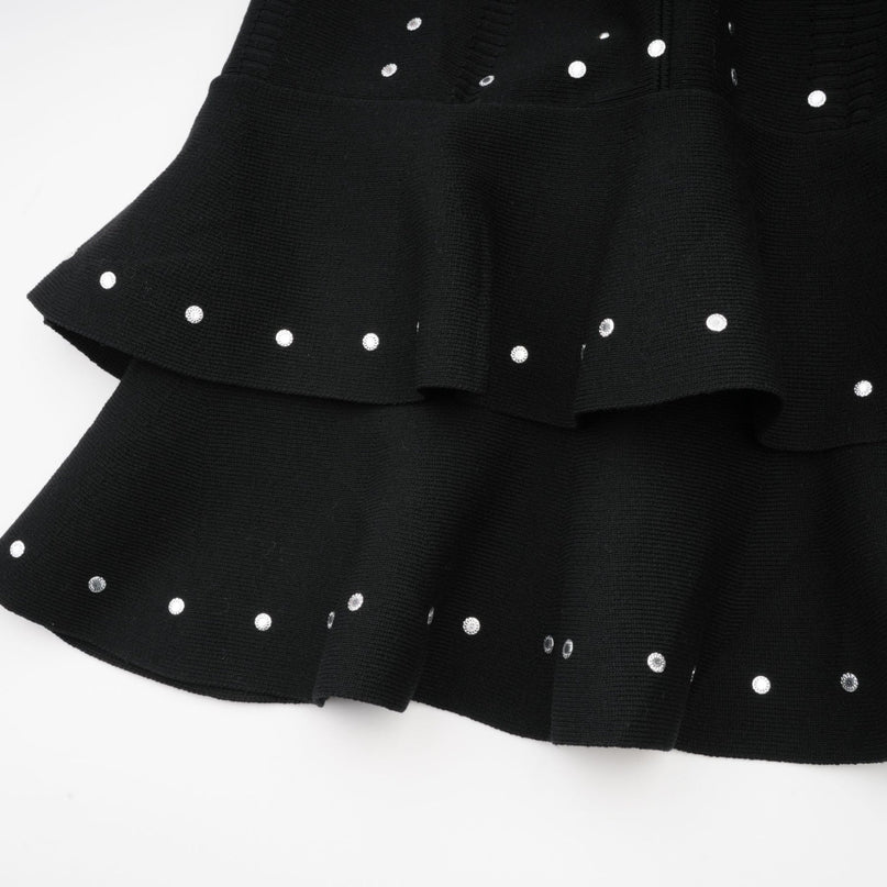A black knitted mini dress with ruffled details and embellishments named Fabienne