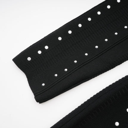 A black knitted mini dress with ruffled details and embellishments named Fabienne