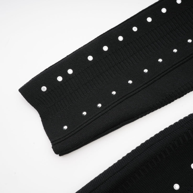 A black knitted mini dress with ruffled details and embellishments named Fabienne