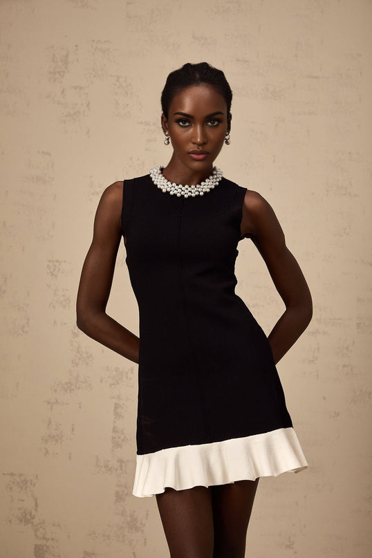 A black knitted mini dress with ruffled details and faux pearl embellishments named Elodie