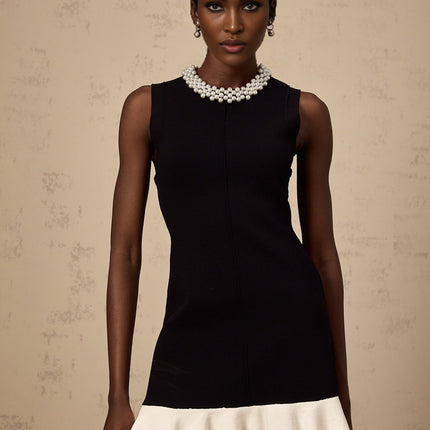 A black knitted mini dress with ruffled details and faux pearl embellishments named Elodie