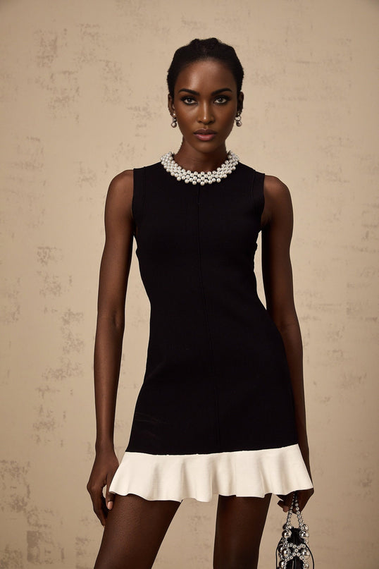 A black knitted mini dress with ruffled details and faux pearl embellishments named Elodie
