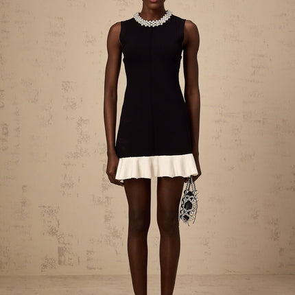A black knitted mini dress with ruffled details and faux pearl embellishments named Elodie
