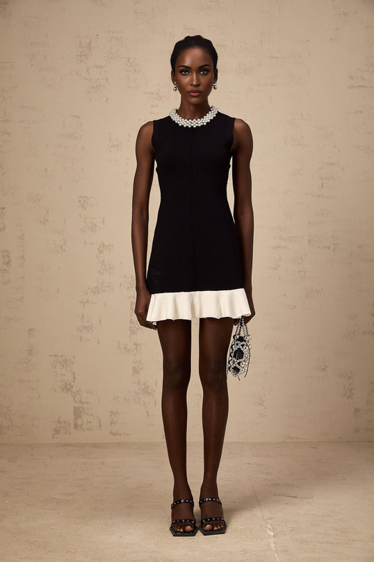 A black knitted mini dress with ruffled details and faux pearl embellishments named Elodie