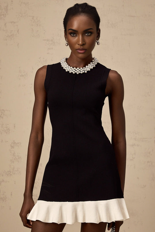A black knitted mini dress with ruffled details and faux pearl embellishments named Elodie