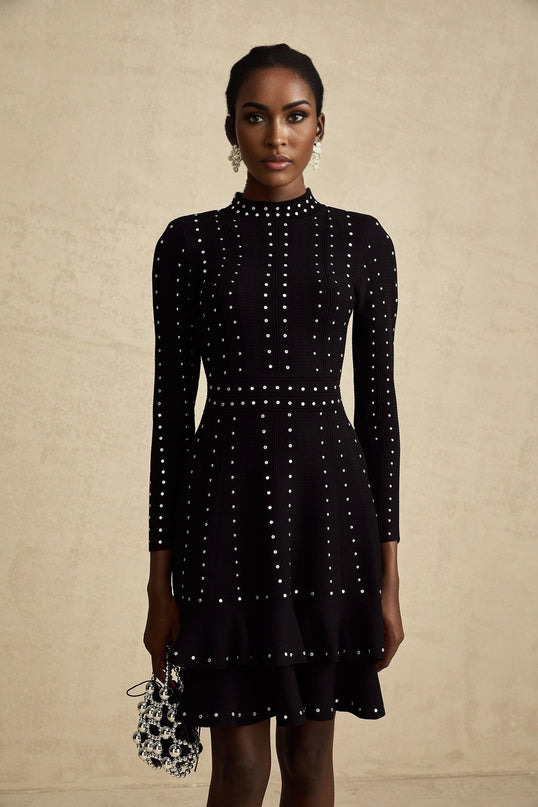 A black knitted mini dress with ruffles and embellishments named Fabienne featuring a short hemline and decorative details