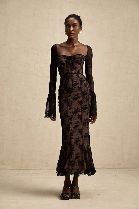 A black lace maxi dress with flared sleeves and a flowing skirt featuring an allover lace pattern and a formfitting silhouette