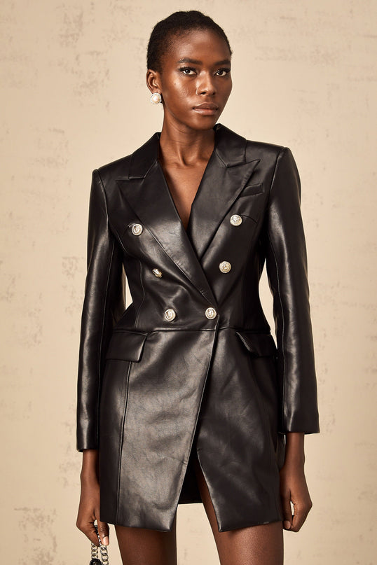 A black leather blazer mini dress featuring a tailored fit collar lapels and long sleeves styled as a short dress with a feminine silhouette