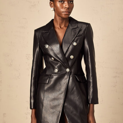 A black leather blazer mini dress with a fitted silhouette worn by a model against a plain background
