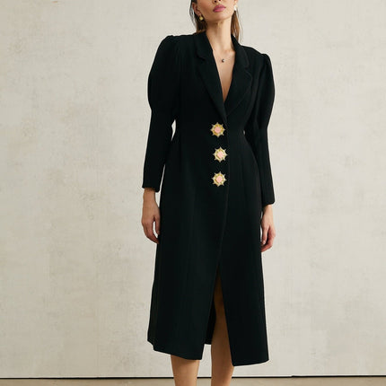 A black long single breasted coat by Aelle