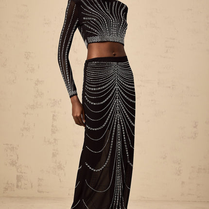 A black matching set consisting of a mesh top and skirt adorned with rhinestones featuring a shimmering and elegant design