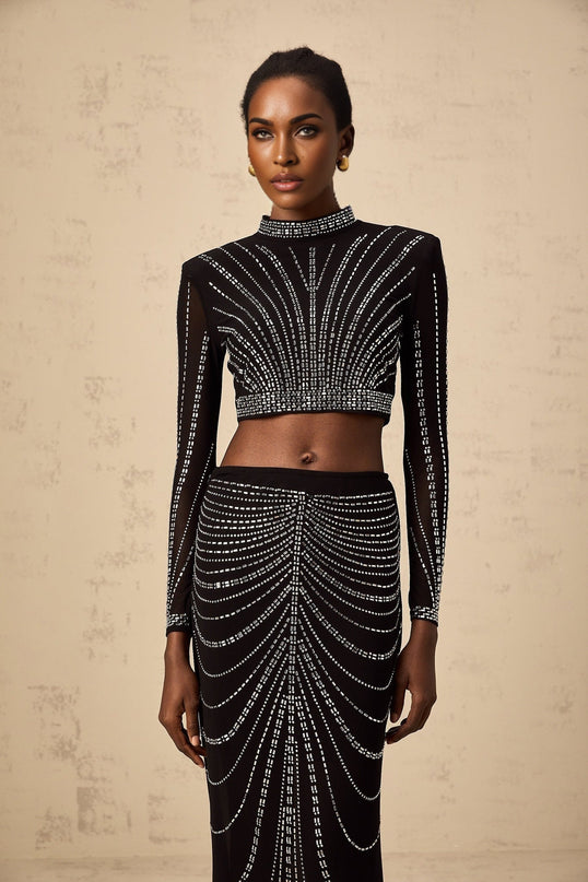 A black matching set consisting of a mesh top and skirt adorned with rhinestones featuring a stylish design by Phillis