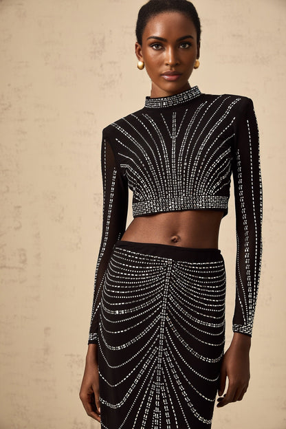 A black matching set featuring a mesh top and skirt adorned with rhinestone embellishments
