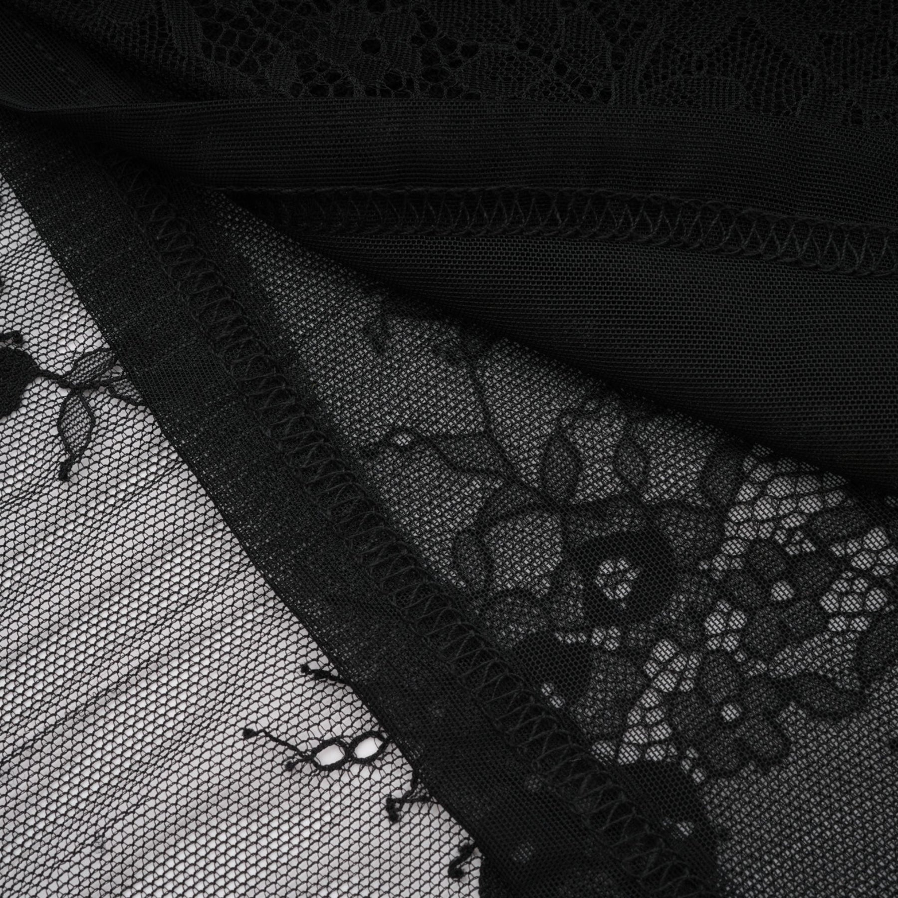 A black lace dress with crystal embellishments and an asymmetric style