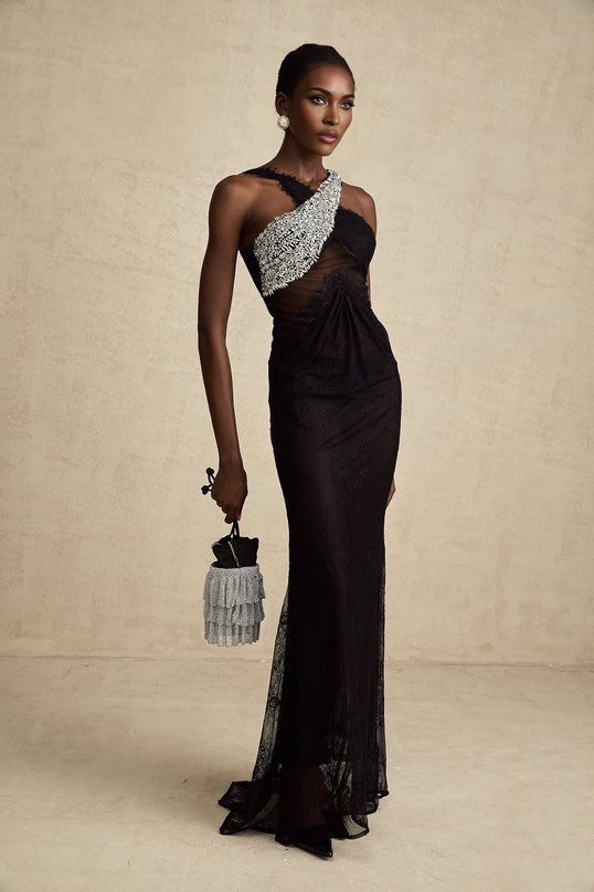 A black maxi dress with a crossover bodice featuring crystal embellishments and a long flowing skirt