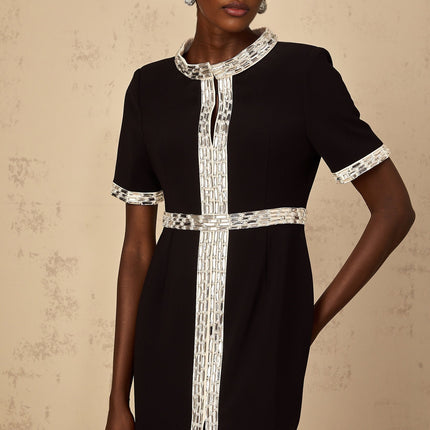 A black maxi dress with a front slit and crystal embellishments worn by a model standing against a plain background