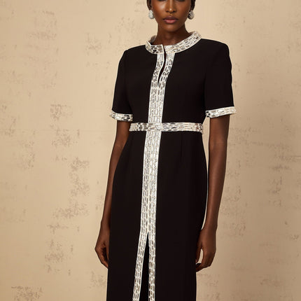 A black maxi dress with a front slit and crystal embellishments worn by a model