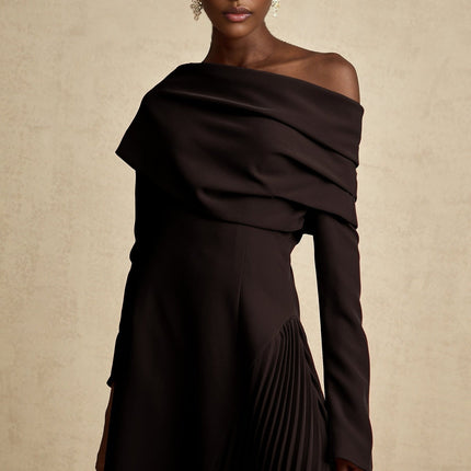 A black maxi dress with a high slit and pleated design suitable for Valentines Day featuring a long flowing skirt and elegant silhouette