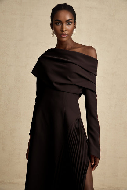 A black maxi dress with a high slit and pleated design suitable for Valentines Day featuring a long flowing skirt and elegant silhouette