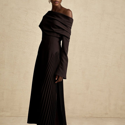 A black maxi dress with a high slit and pleated design suitable for Valentines Day occasions