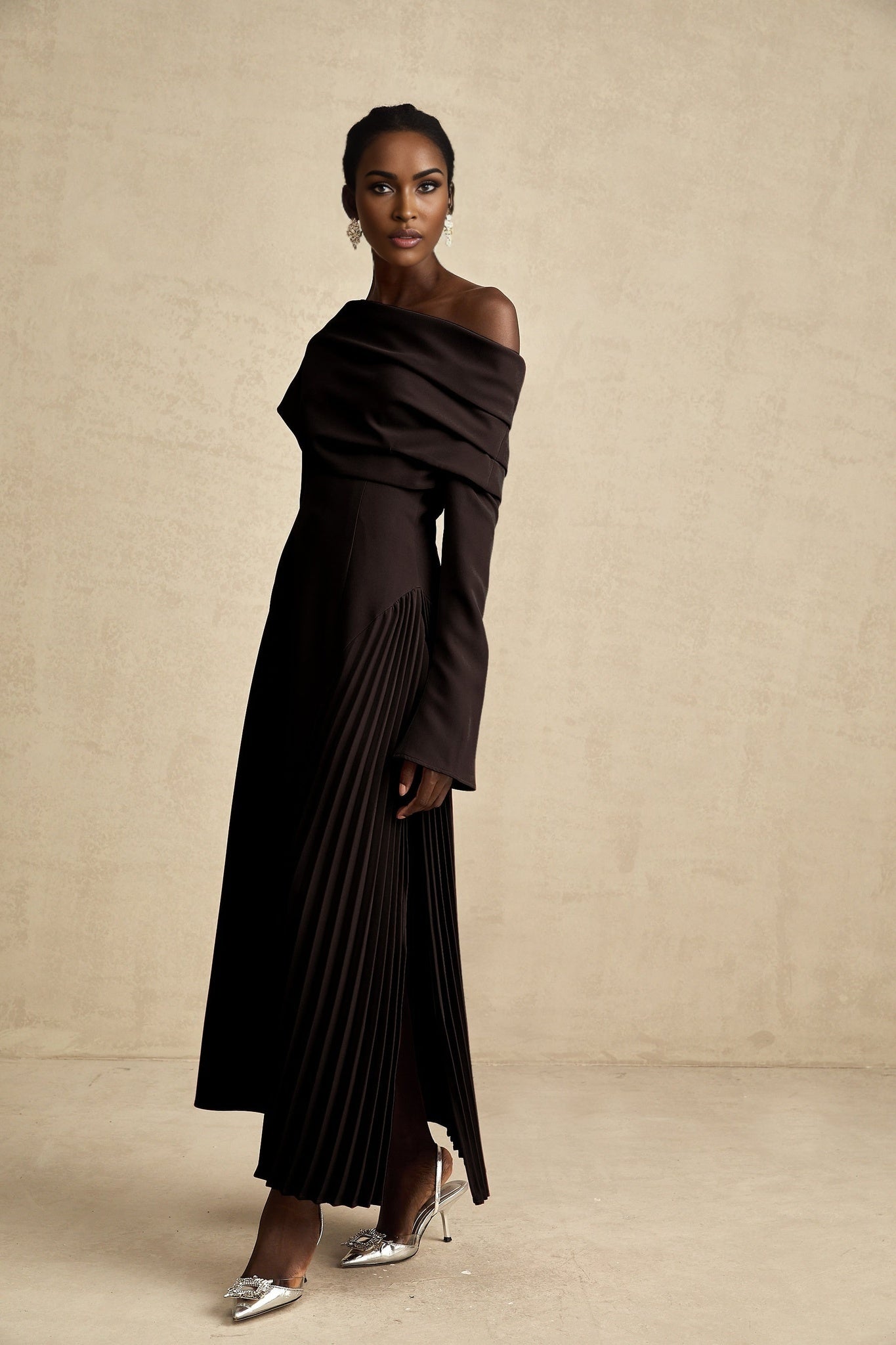 A black maxi dress with a high slit and pleated design suitable for Valentines Day occasions