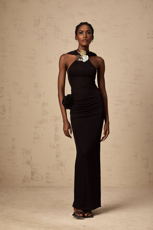 A black maxi dress with a hood featuring floral appliques and named Axelle