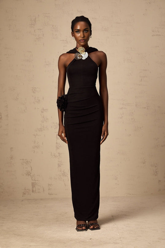A black maxi dress with a hood featuring floral appliques on the fabric