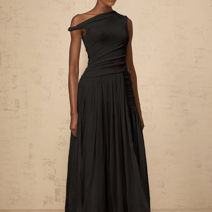 A black maxi dress with a single shoulder strap and shirred panels featuring a fitted bodice and flowing skirt