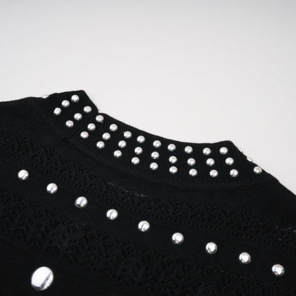 A black maxi dress with crochet knit details and studded embellishments designed by Chloé featuring a long flowing silhouette