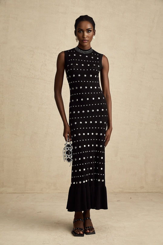 A black maxi dress with crochetknit design and studded embellishments by Chloé featuring long sleeves and a flowing silhouette