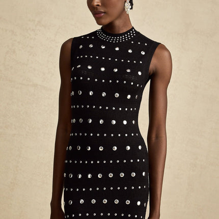 A black maxi dress with crochetknit pattern and studded details designed by Chloe featuring a long silhouette and intricate texture