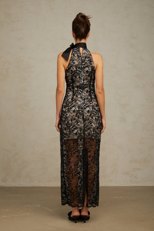A black maxi dress with floral lace pattern featuring a halterneck design named Coralie