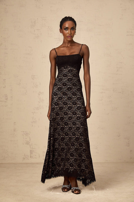 A black maxi dress with floral lace patterns and an open back design named Zelie
