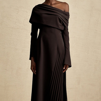 A black maxi dress with high slit and pleated design suitable for Valentines Day occasion