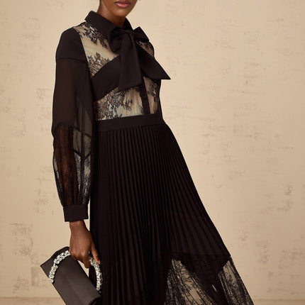 A black maxi dress with pleated design and floral lace panels named Segolene